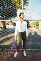 Model on tennis court with racket modeling 2-1 Original Skirted Mid-calf Length Leggings in Dark Olive - Sol Sister Sport